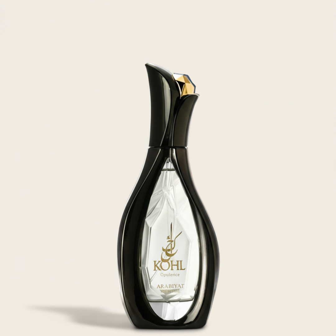 A sleek black perfume bottle with a clear center and gold-embossed label reads "Kohl Opulence 100ml EDP - Arabiyat Prestige" by Arabiyat Prestige, featuring gold Arabic script and a black cap with gold accent.