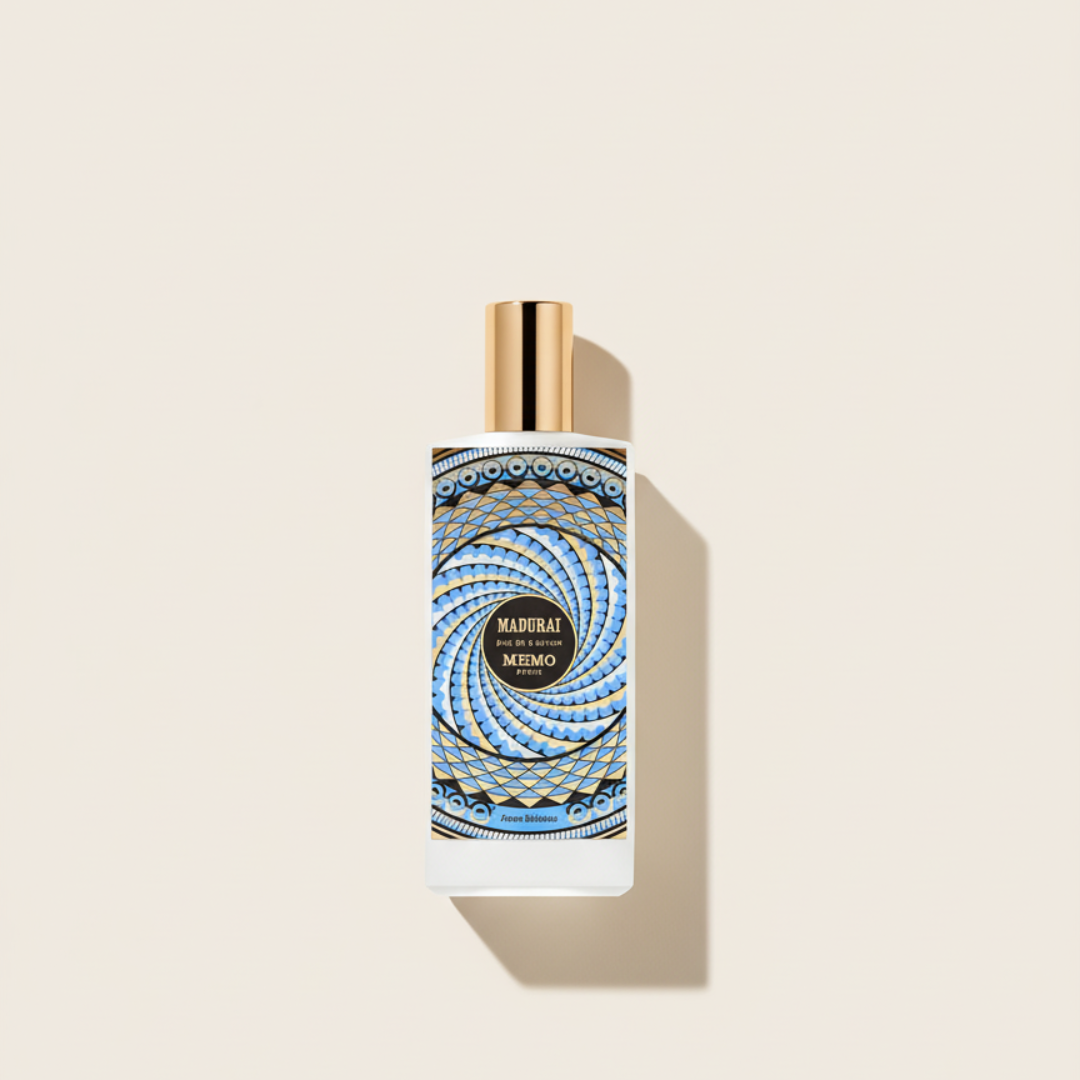 A 75ml Memo Paris perfume bottle with a gold cap and intricate blue-gold geometric label, set on a light beige background. This floral fragrance is called Madurai EDP.