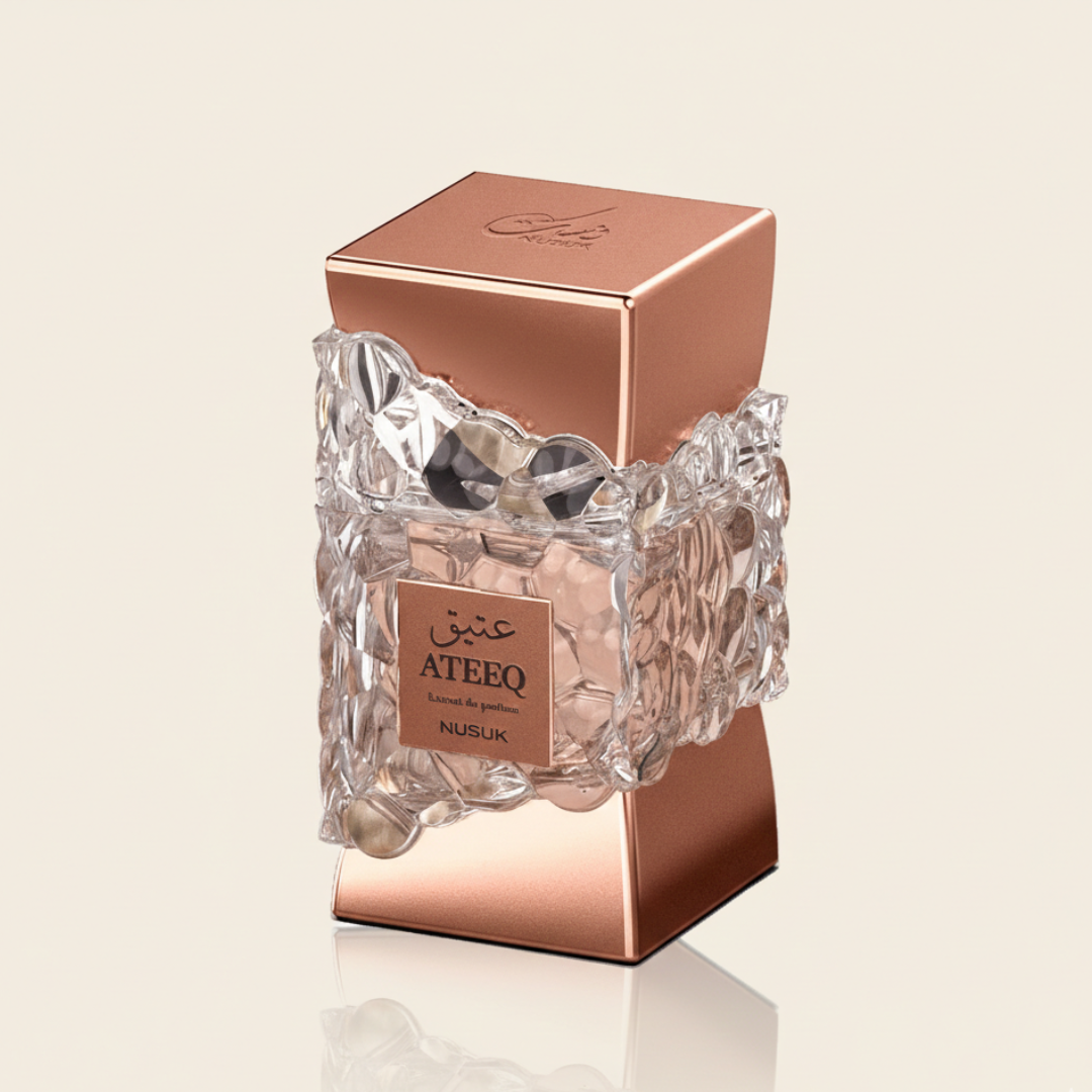 A rose gold perfume bottle labeled "Ateeq 100ml EDP - Riiffs" features a geometric glass design with intricate, bubble-like textures around the center, embodying the bold essence of this Riiffs fragrance. The background is plain light beige.