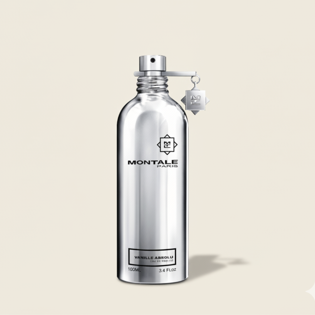A metallic silver Montale Vanille Absolu 100ml EDP bottle stands upright on a light background, labeled with the brand name and fragrance, featuring a small tag on the neck and a subtle shadow below.