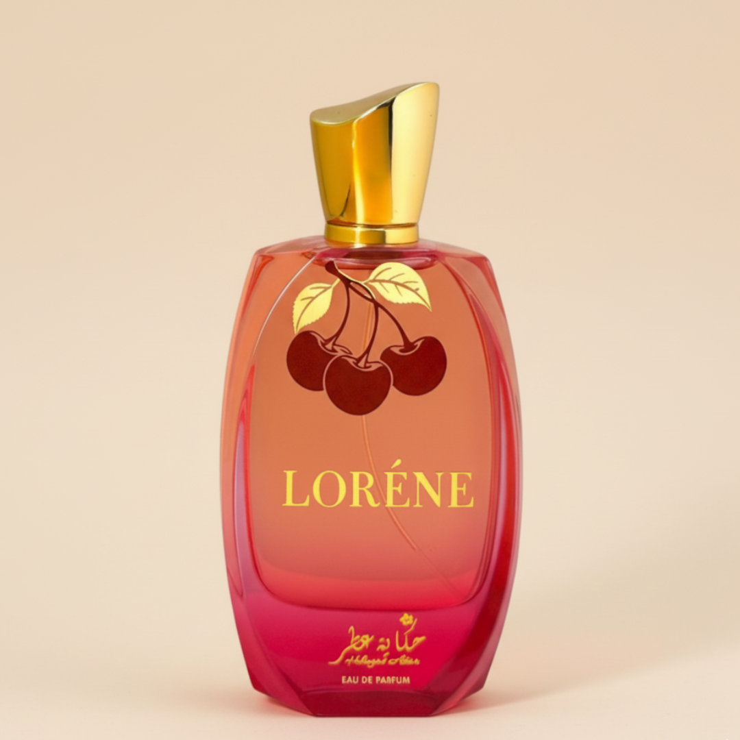 A red and gold "Lorene 100ml EDP - Hekayat Attar" perfume bottle from Hekayat Attar displays two cherries and gold text on a light beige background, suggesting a sophisticated, long-lasting fragrance.