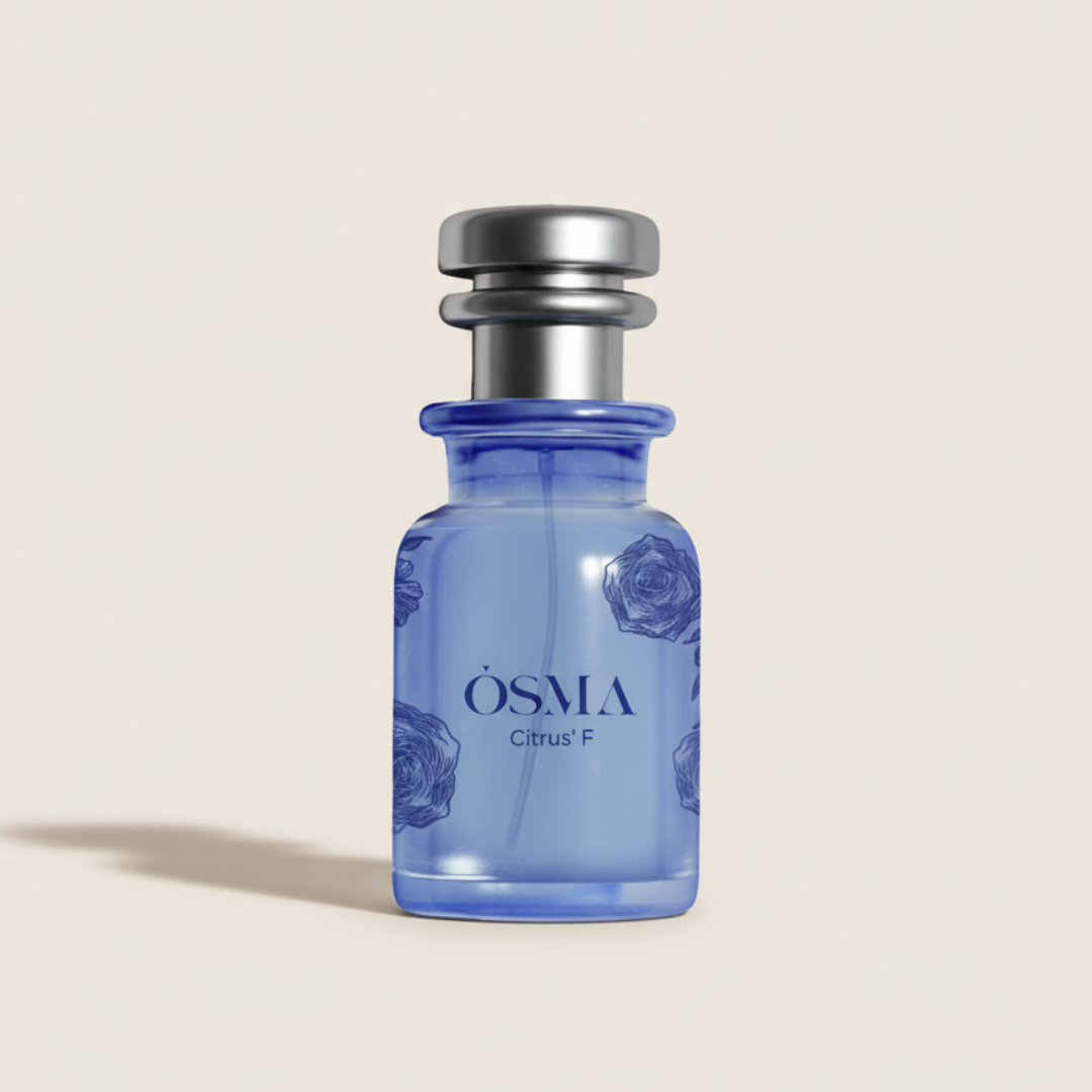 The Citrus F 75ml EDP by Osma is a small blue glass perfume bottle with a metallic silver cap and subtle floral designs, offering a refreshing citrus scent. It’s shown against a plain light background.