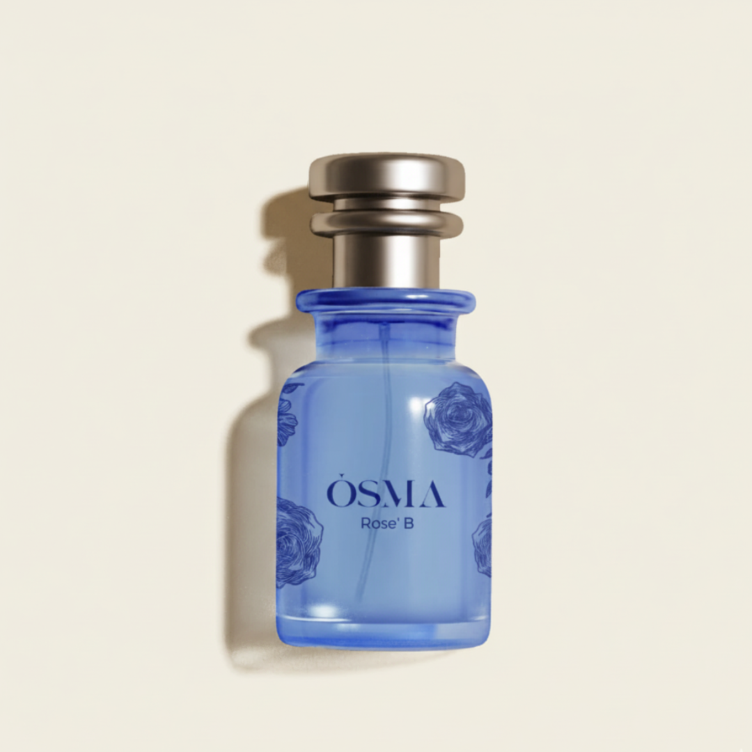A blue glass “Rose P 75ml EDP - Osma” perfume bottle with floral designs and a metallic cap evokes rose fragrance, casting a soft shadow on a light beige background.
