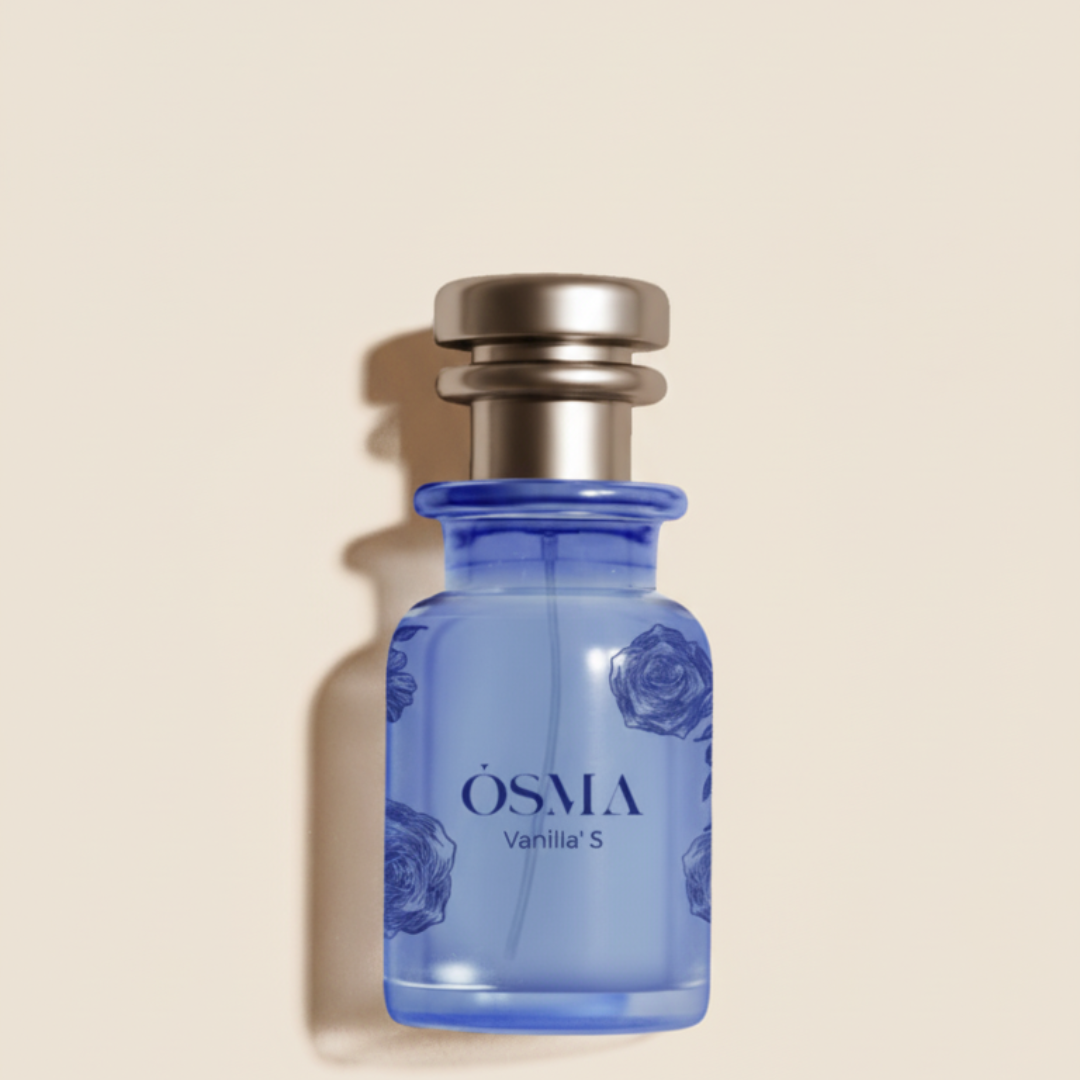 A blue glass bottle of Osma's Vanilla S 75ml EDP with a silver cap and floral patterns rests on a light beige background, casting a soft shadow—an elegant presentation of vanilla and tuberose musk fragrance.