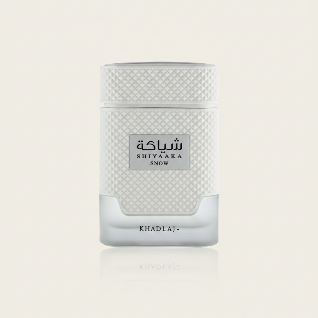 The Shiyaaka Snow 100ml EDP by Khadlaj features a white and silver rectangular bottle with textured patterns and dual-language labeling—ideal for fans of fresh fragrances.