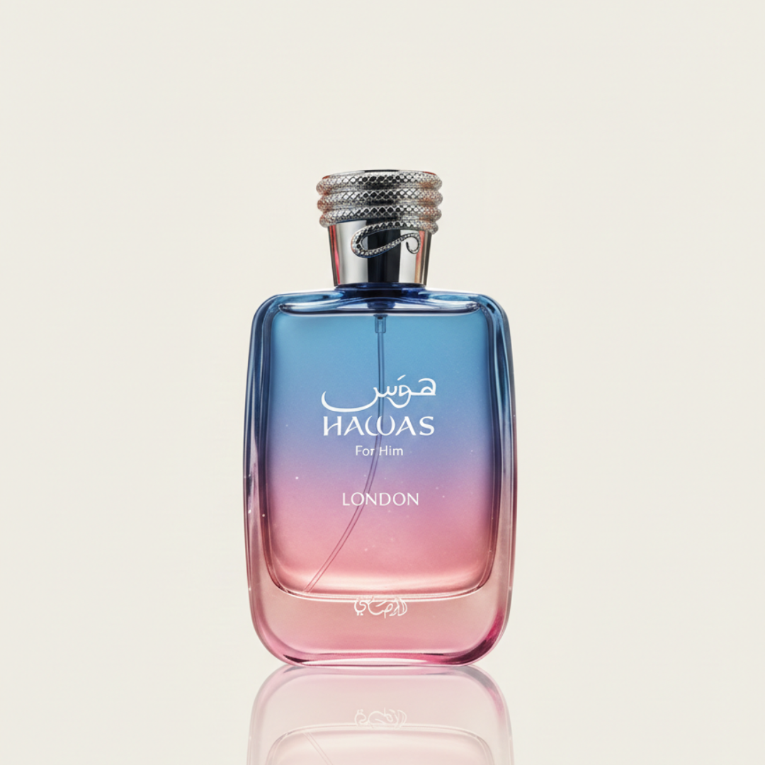 A bottle of "Hawas London 100ml EDP - Rasasi" by Rasasi, featuring a blue-to-pink gradient, silver cap, and white text, stands upright on a reflective surface against a light background, reflecting Hawas London's seductive perfume style.