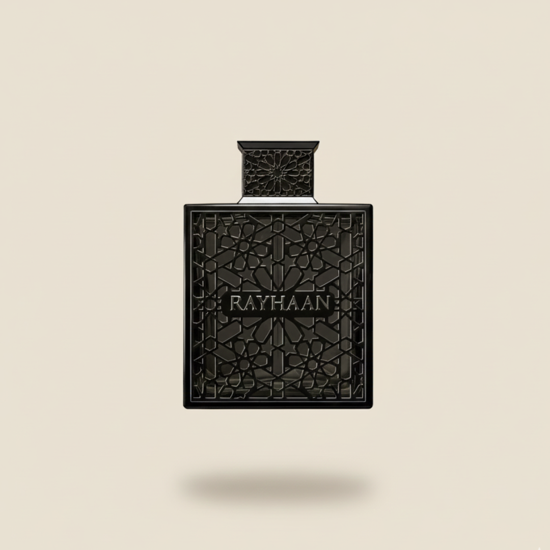 A black "Obsidian 100ml EDP - Rayhaan" bottle by Rayhaan, featuring intricate geometric patterns and central branding, set against a beige backdrop—an homage to modern scent with notes of sueded leather.