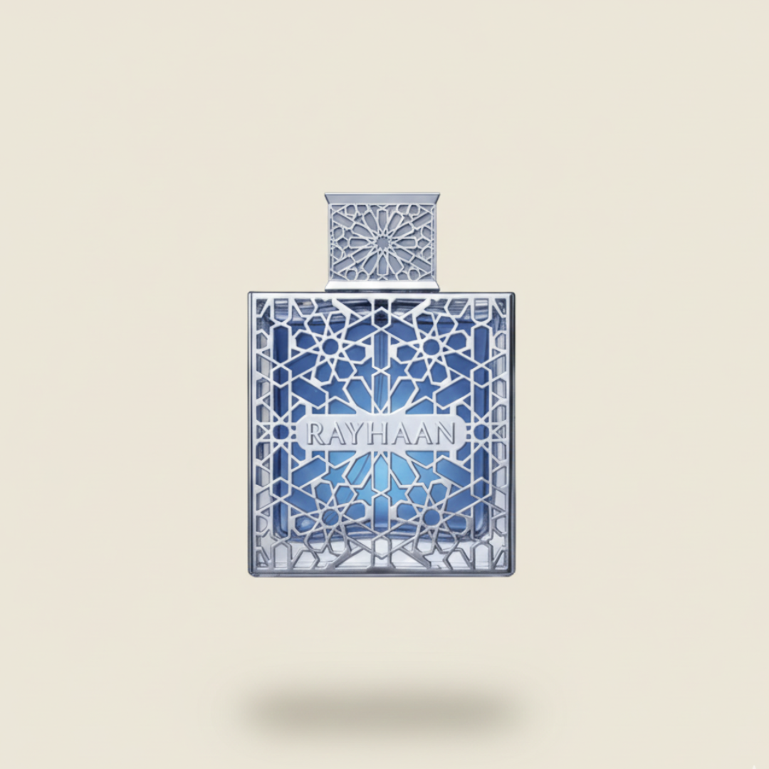 The "Aquatica 100ml EDP - Rayhaan" by Rayhaan features intricate silver geometric patterns on translucent blue glass, reflecting a tropical allure, set against a light beige background.