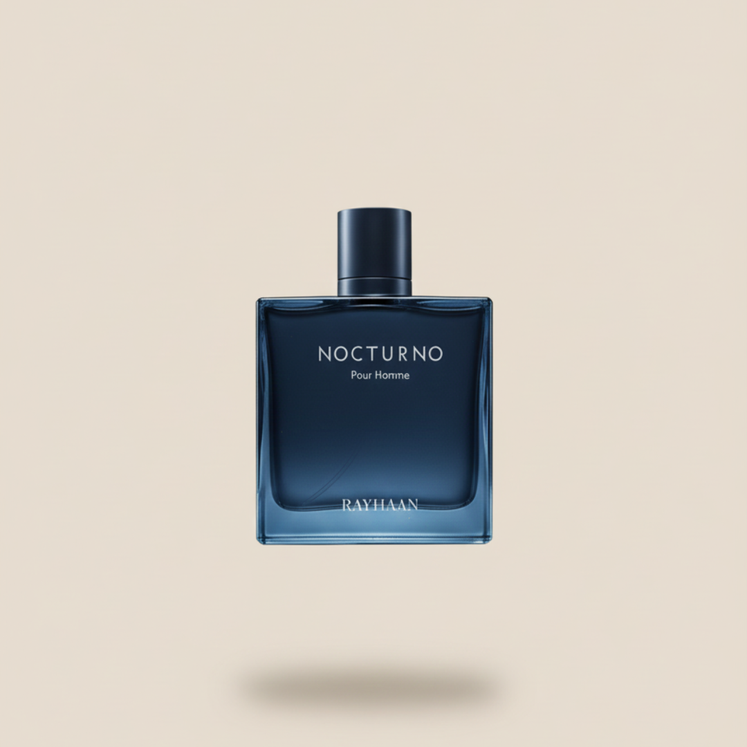 A blue glass bottle of Nocturno 100ml EDP by Rayhaan, a long-lasting and masculine fragrance, sits centered on a beige background with a soft shadow beneath it.