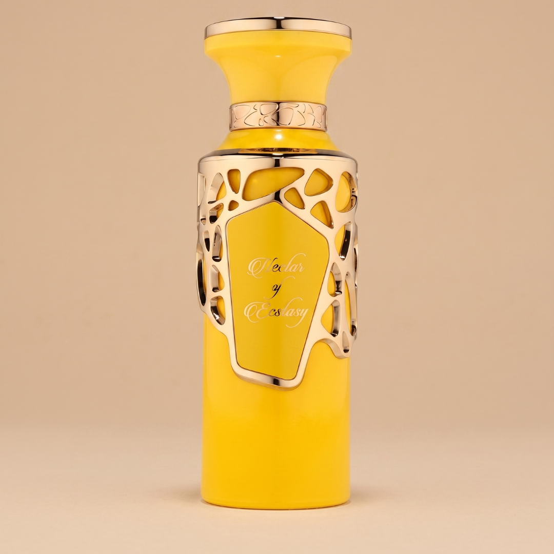 A yellow perfume bottle with an ornate silver overlay and matching cap sits on a beige background. "Nectar Of Ecstacy" is scripted on the front—a sweet gourmand 100ml EDP fragrance by Fragrance World.