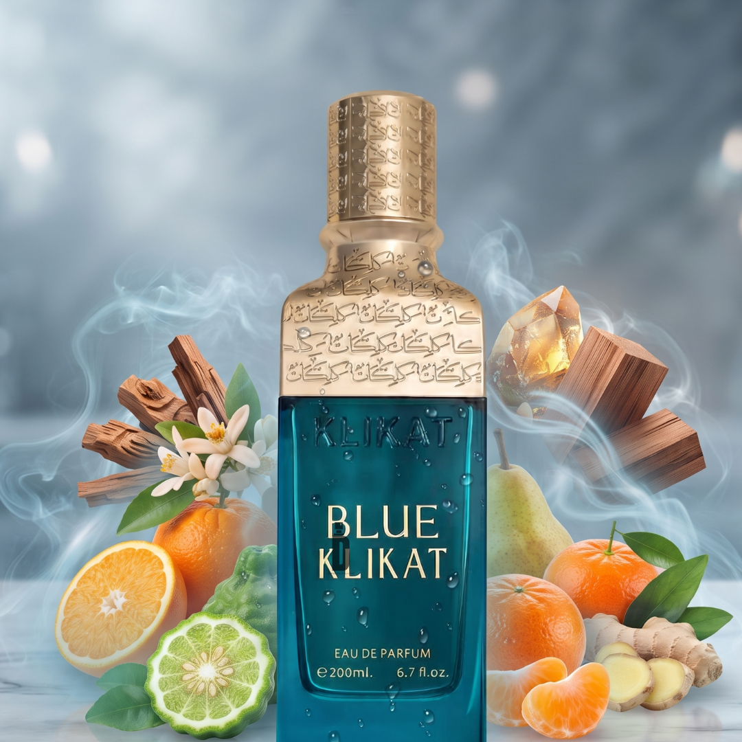 A striking blue perfume bottle labeled "Blue Kilkat 200ml EDP - Alezz Oud" by Alezz Oud, adorned with elegant gold accents, is encircled by fresh pear, citrus, tangerine, spicy ginger and cinnamon, woody notes, and aromatic florals. Set against a smoky and dreamy backdrop, this composition captures the mesmerizing essence of modern fragrance. Refined touches inspired by Alezz Oud lend an added layer of depth and sophistication to the scene.