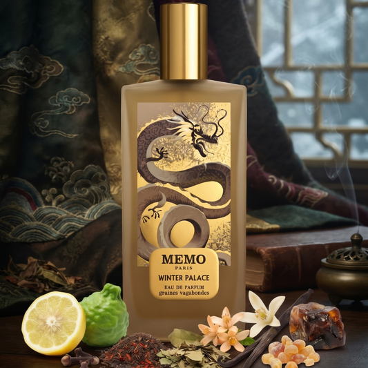 A rectangular Winter Palace 75ml EDP - Memo Paris perfume bottle featuring a gold dragon illustration, surrounded by scattered red tea leaves, citrus fruit, vanilla beans, and flowers.