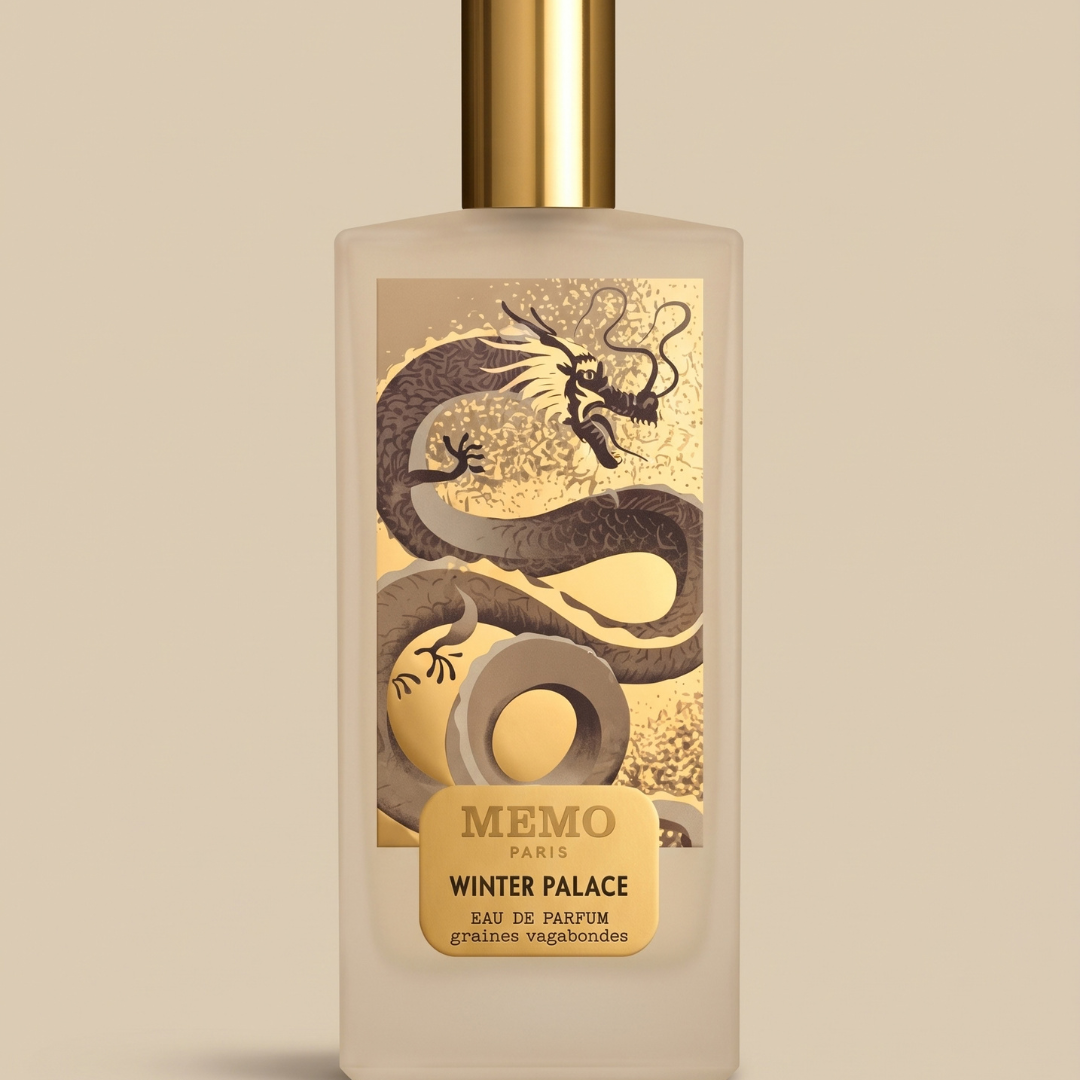 A rectangular Winter Palace 75ml EDP - Memo Paris perfume bottle featuring a gold label with a dragon illustration and the text “Memo Paris Winter Palace Eau de Parfum Graines Vagabondes.”.