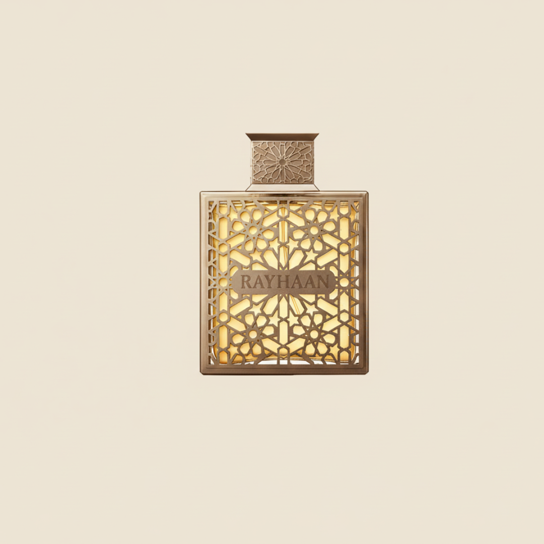 A gold perfume bottle with intricate geometric patterns and "Rayhaan" at the center, set against a cream background, showcases Terra 100ml EDP—a statement fragrance by Rayhaan.