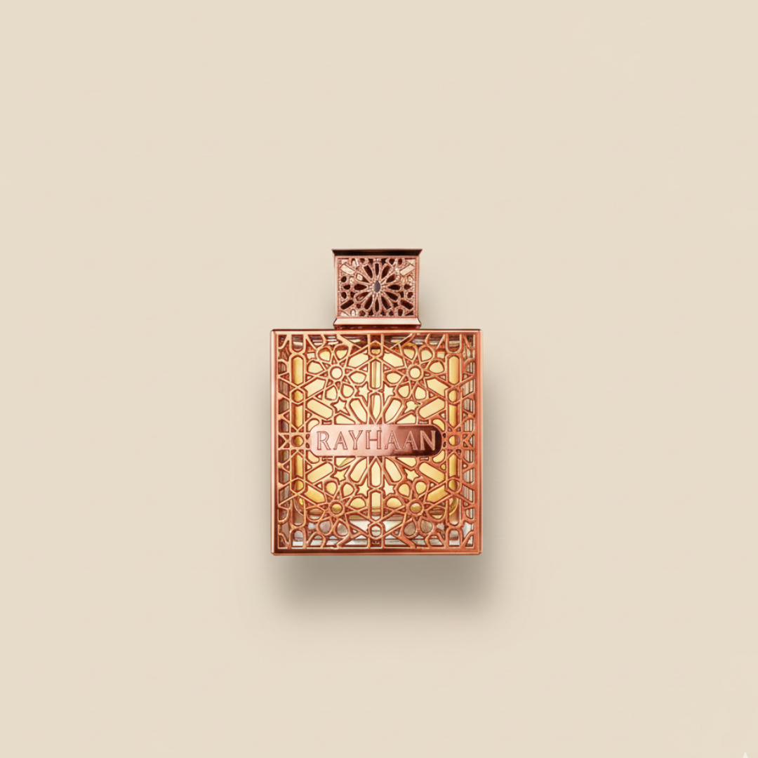 The Rayhaan Divine 100ml EDP features a square bottle adorned with golden geometric patterns, set against a plain beige background—an exquisite presentation of fruity freshness.