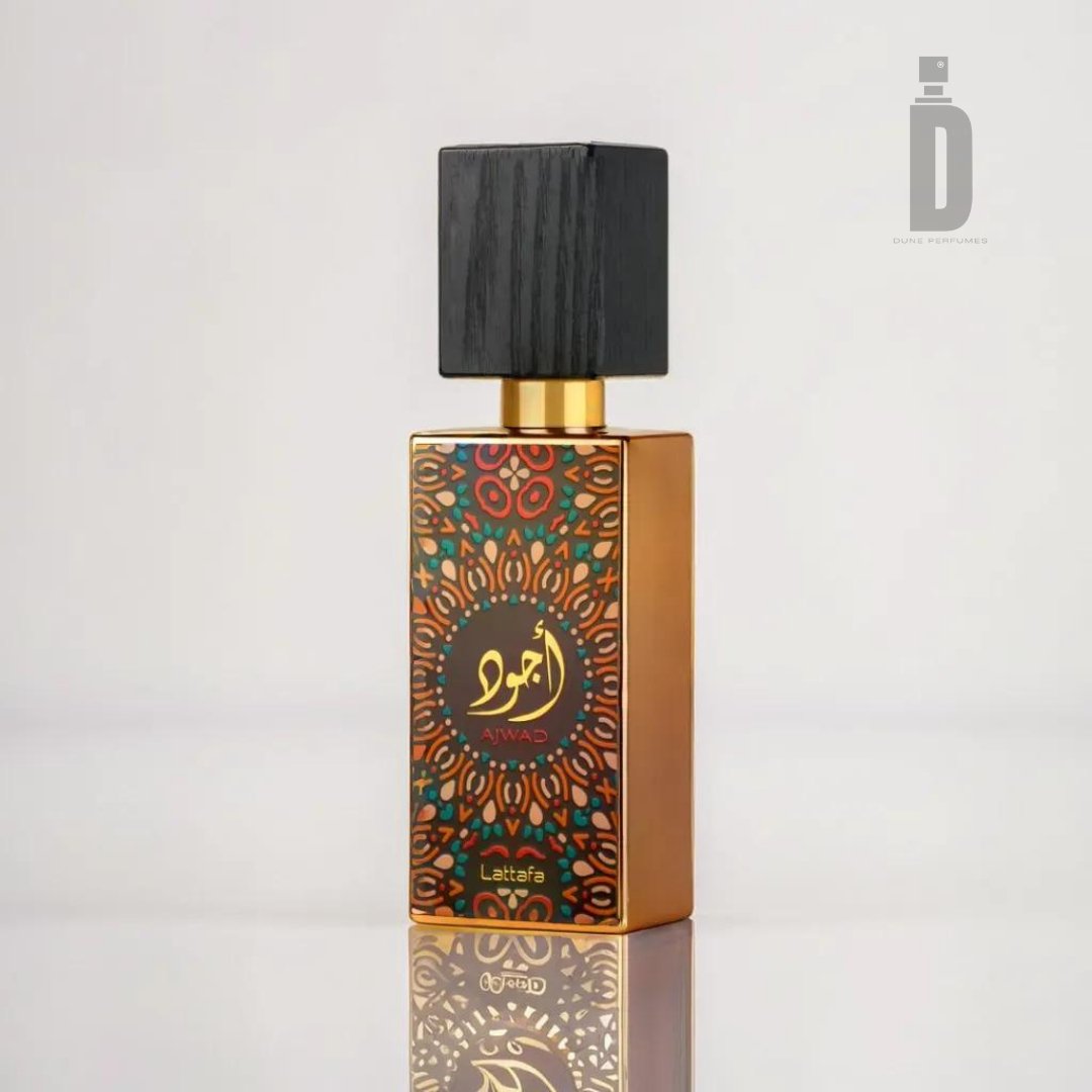 The Ajwad 60ml EDP by Lattafa is a sophisticated perfume housed in a rectangular bottle adorned with an intricate, colorful front design. It features a black square cap and a label that showcases ornate patterns and text in an unknown script, exuding its alluring Ajwad fragrance.