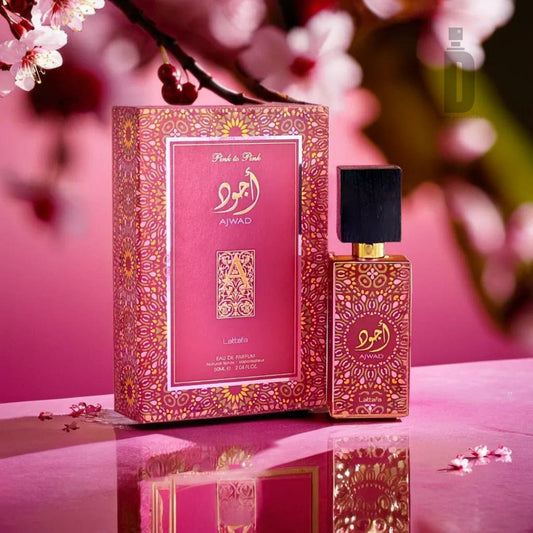 A luxurious pink and gold perfume bottle labeled "Ajwad Pink To Pink 60ml EDP - Lattafa" stands next to its matching ornate box featuring Arabic script. Both are adorned with intricate patterns, set against a blurred backdrop of blooming peonies. The design exudes elegance and opulence, capturing the essence of this feminine Lattafa fragrance.