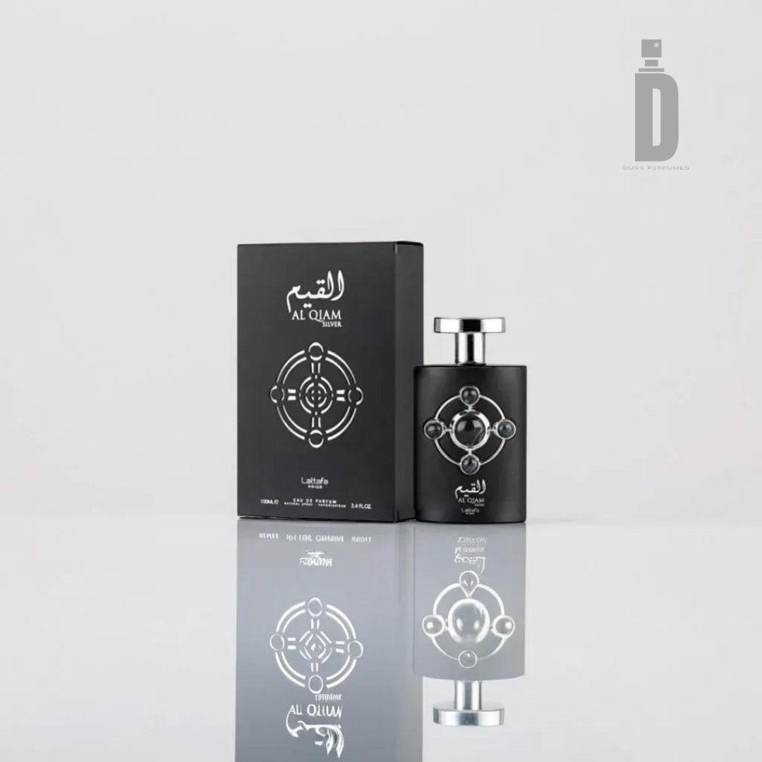 A sleek black perfume bottle with silver accents, Al Qiam Silver 100ml EDP from Lattafa Pride, stands next to its matching box. Both feature intricate circular silver designs and Arabic text. The background is clean and minimalist, emphasizing the sophistication of this exquisite fragrance from Lattafa.