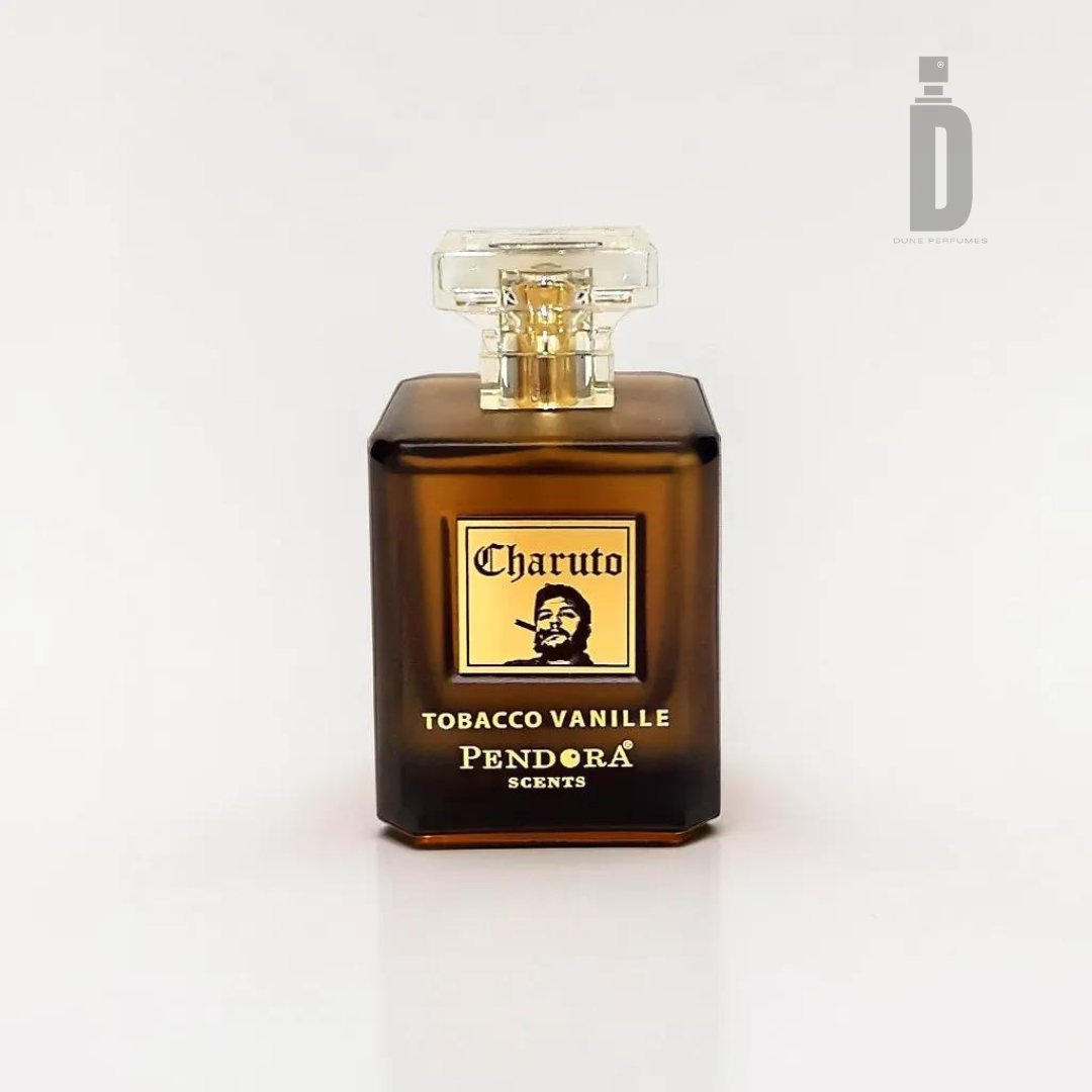 A rectangular, dark amber perfume bottle with a transparent cap displays the label "Charuto Tobacco Vanille 100ml EDP - Paris Corner," featuring an illustration of a man's face with a hat. Below, the text says "Pendora Scents." This sophisticated scent exudes the essence of luxury fragrance and is placed on a plain white background.