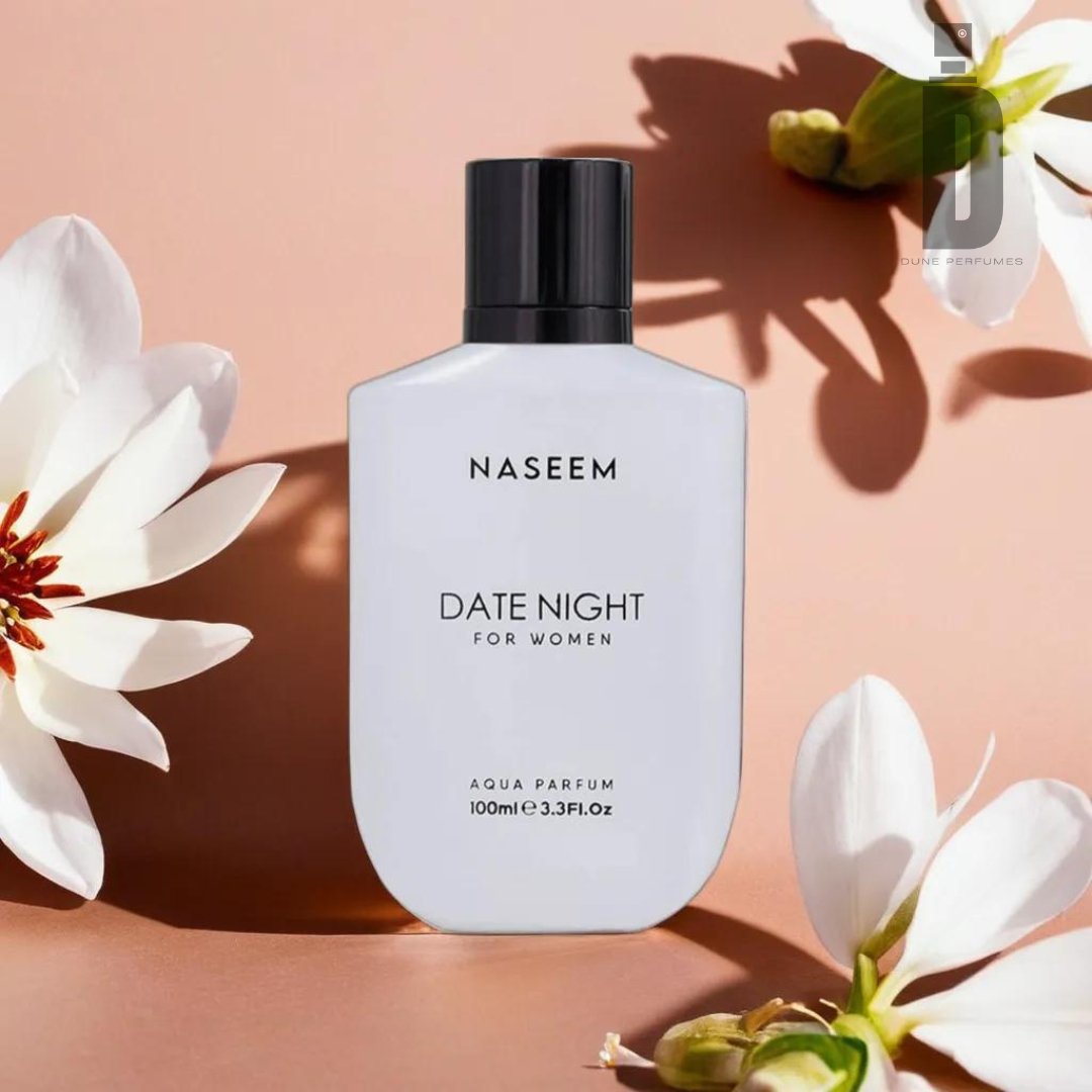 A bottle of Naseem Perfumes' alcohol-free "Date Night For Women 100ml Aqua Parfum" stands upright, featuring a sleek black cap. The white bottle is beautifully accentuated by surrounding white flowers and their graceful shadows, all set against a warm beige backdrop. This romantic fragrance comes in a 100ml (3.3 fl oz) size.