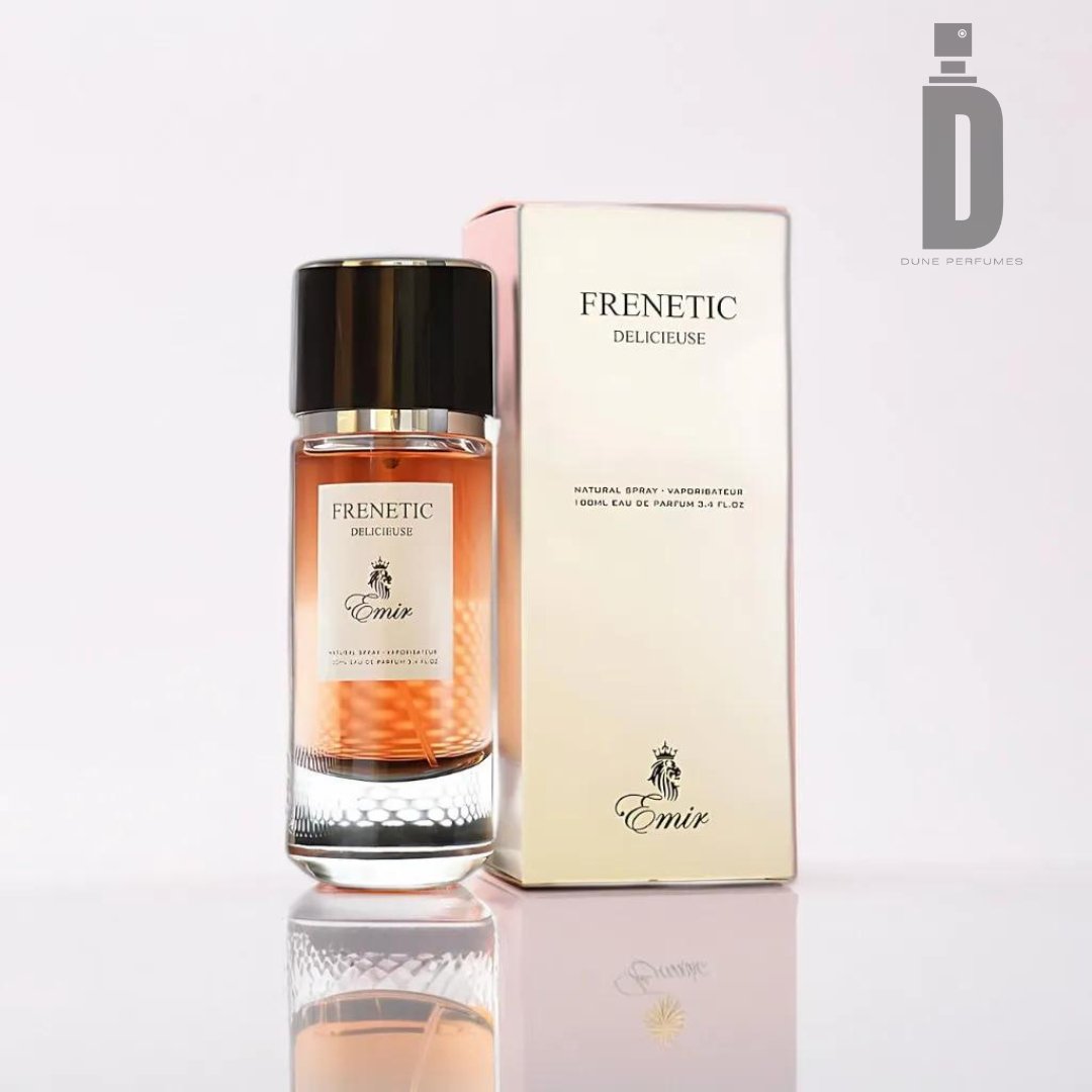 An 80ml bottle of Paris Corner's Frenetic Delicieuse 80ml EDP - Emir stands next to its beige and peach-hued packaging box. The clear bottle showcases a gradient amber liquid, exuding a sweet, warm fragrance, topped with a black and silver cap. "FRENETIC DELICIEUSE" and "Emir" are elegantly printed on both the bottle and the box.