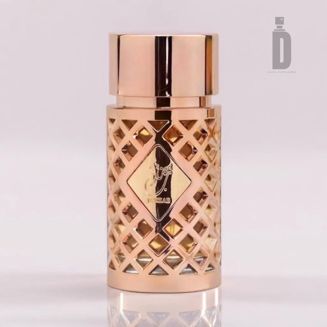 The Jazzab Gold 100ml EDP by Ard Al Zaafaran boasts a luxurious perfume bottle with an intricate lattice design in a shiny gold finish. The bottle is capped with a solid gold-toned lid and features an elegant black and gold label at the center, exuding sophistication. Set against a clean, plain white background, this exquisite fragrance stands out beautifully.