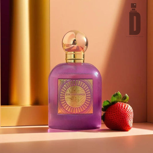 A purple perfume bottle with a gold cap sits on a peach-colored surface. The label on the bottle reads "Juicy Melange 100ml EDP - Paris Corner." A fresh strawberry is placed next to the bottle, hinting at its summer fragrance. The background features a gradient of warm shades, evoking a tropical vibe.