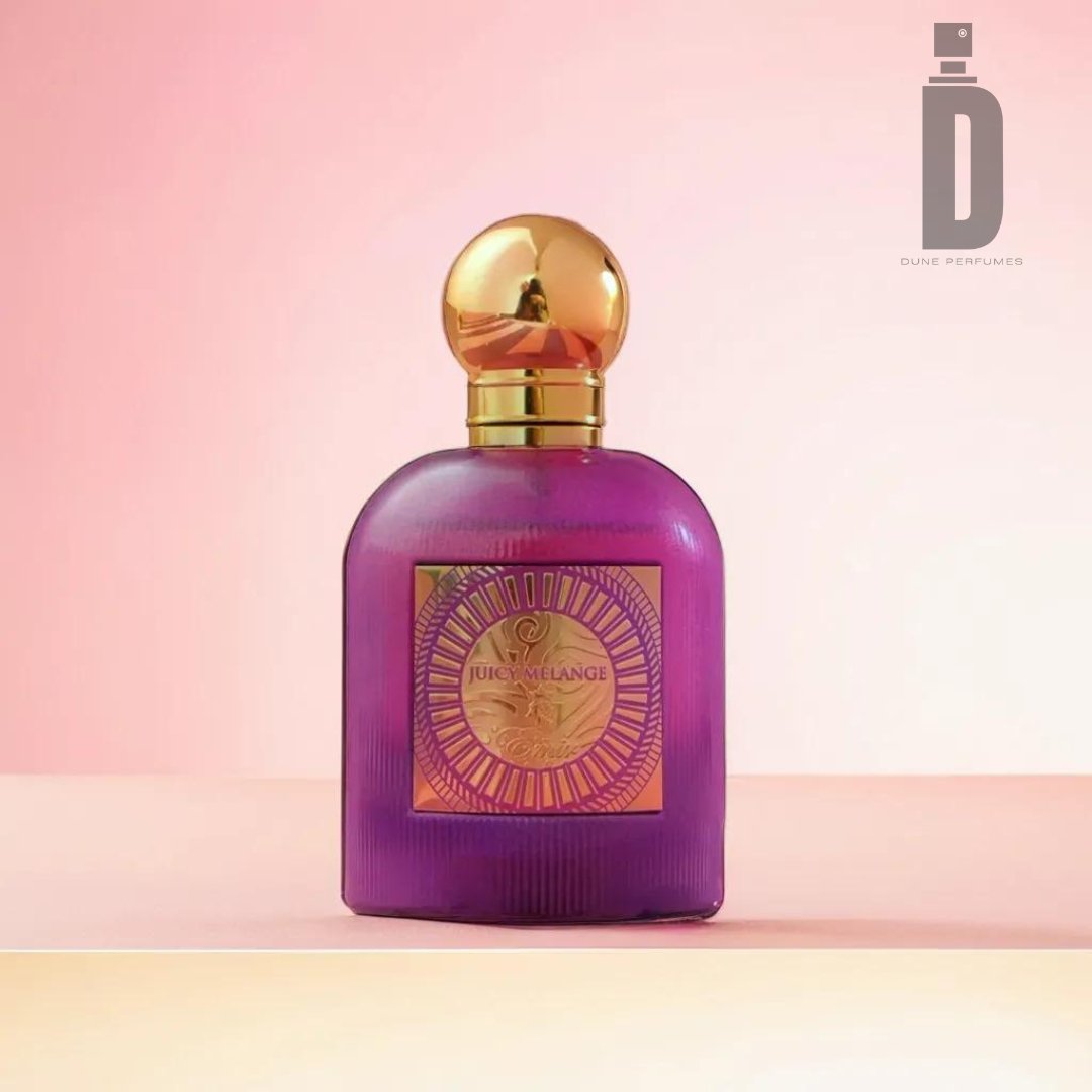 A purple perfume bottle with a gold cap stands on a pink and beige gradient background. The bottle features a label with gold and pink detailing, hinting at its Juicy Melange—a tropical summer fragrance from Paris Corner. The Dune Perfumes logo appears in the top right corner.