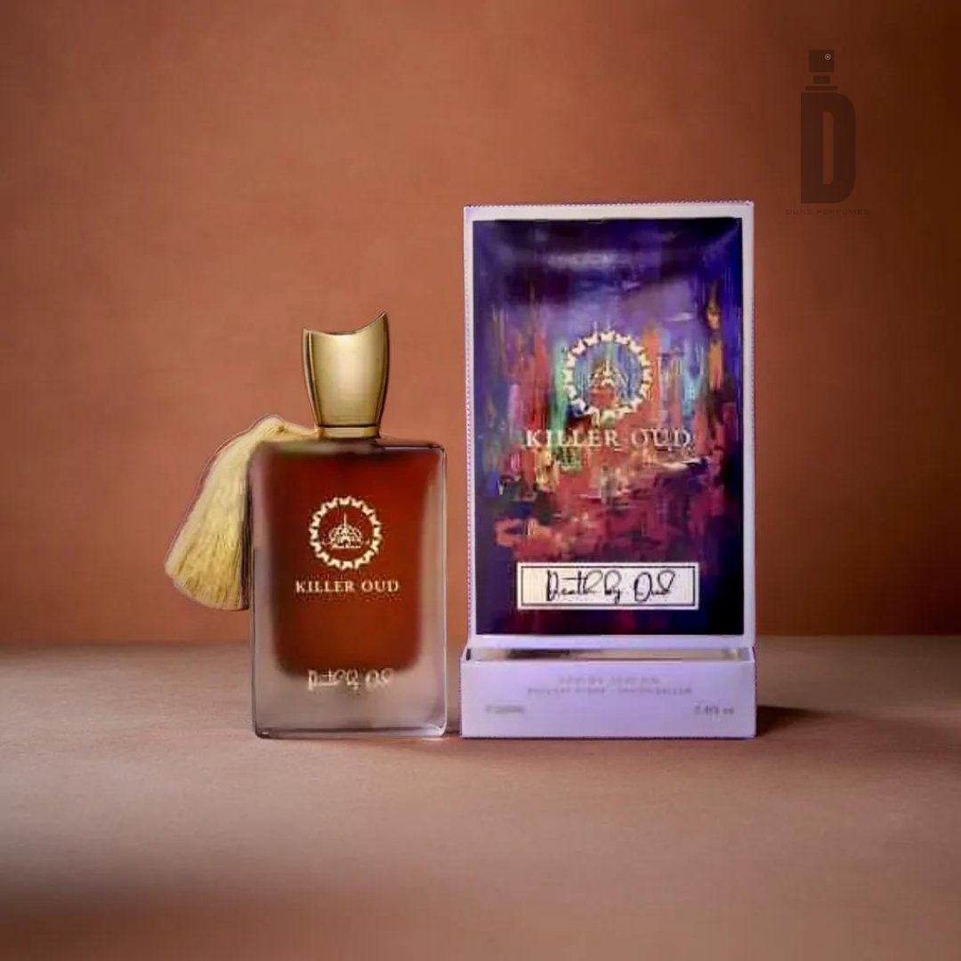 A bottle of Killer Oud Death By Oud 100ml EDP - Paris Corner is displayed against a brown background. The rectangular bottle features a golden cap and a beige tassel. To its right, an open box showcases the fragrance's logo, name, and a colorful design on the inside.