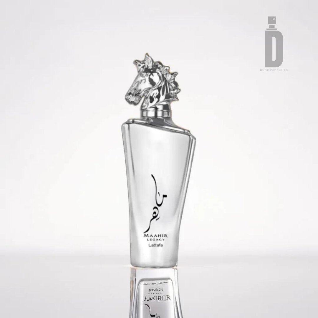 A silver perfume bottle stands upright with an intricately designed cap shaped like a horse's head. The bottle has elegant, angular edges and features text, including the brand name "Lattafa" and the product name "Maahir Legacy 100ml EDP - Lattafa." This fragrance offers a sophisticated blend that resonates perfectly against its minimalistic white background.