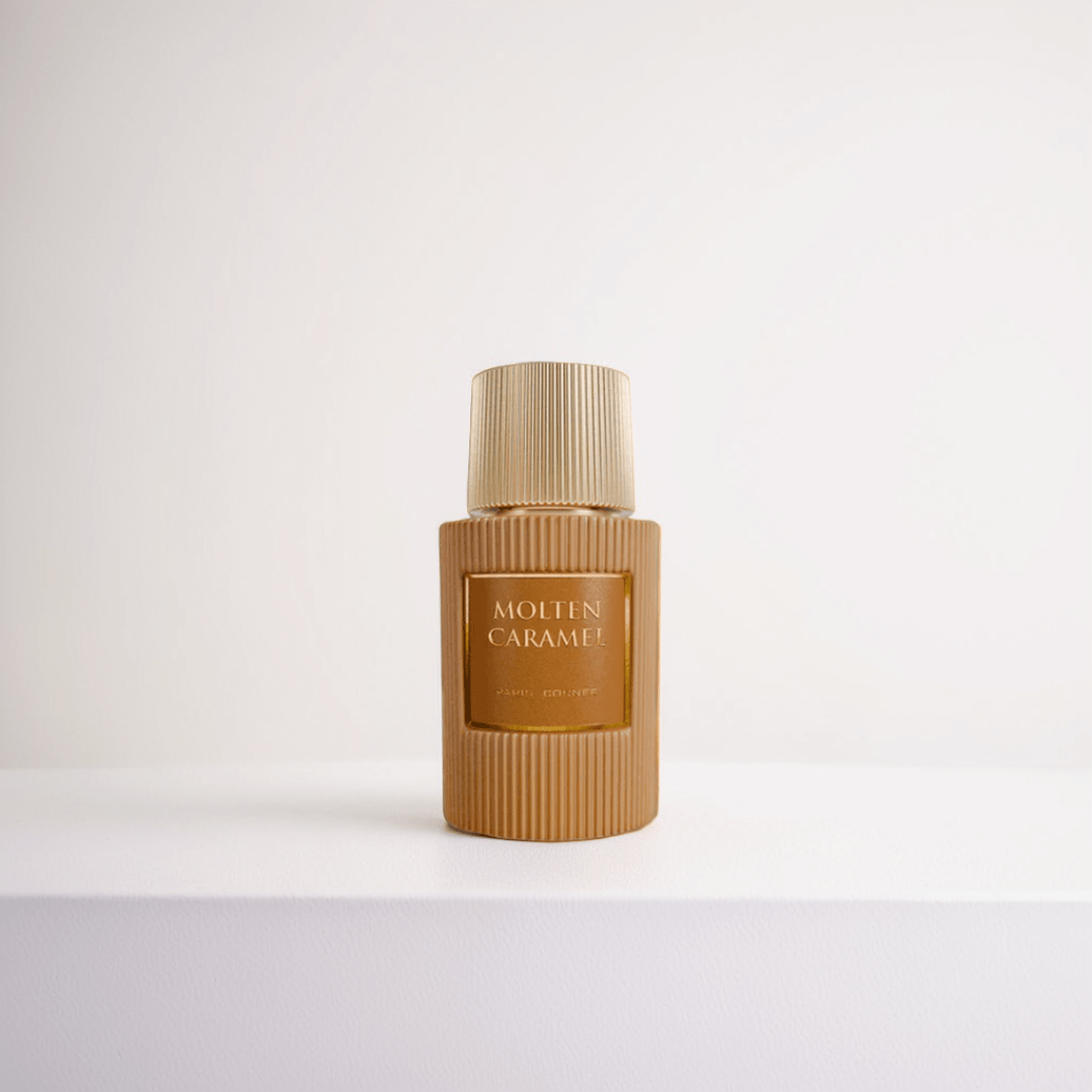 A Molten Caramel 100ml EDP from Paris Corner is displayed against a white background, showcasing the gold ribbed-textured bottle and cap that radiate indulgence, for a cohesive, minimalist look.