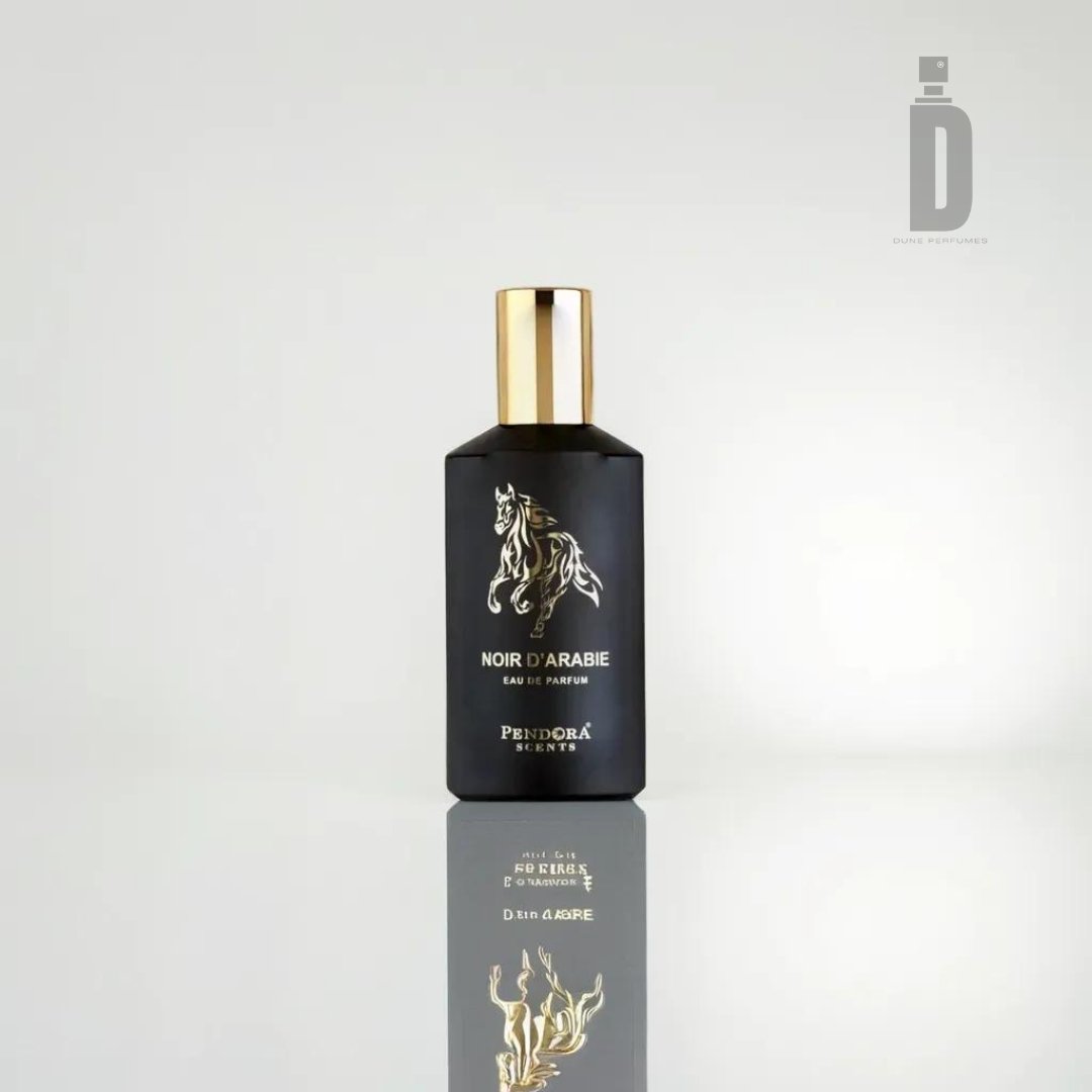 A sleek black bottle of Noir D'Arabie Pendora 100ml Eau de Parfum by Paris Corner. The bottle, featuring a golden cap and a golden horse design on its front, exudes an exotic fragrance with Arabian allure. The reflective surface beneath mirrors its image, set against a plain light-colored background.