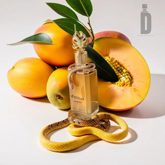 The luxurious and sumptuous fragrance of "Ophidian Mango Bliss 100ml EDP - Paris Corner" is presented in a bottle emblazoned with a stylized snake wrapping around it. The bottle, placed before a cut melon and encircled by whole mangoes and lush greenery, offers an exotic visual delight, perfectly capturing the essence of this Paris Corner creation.