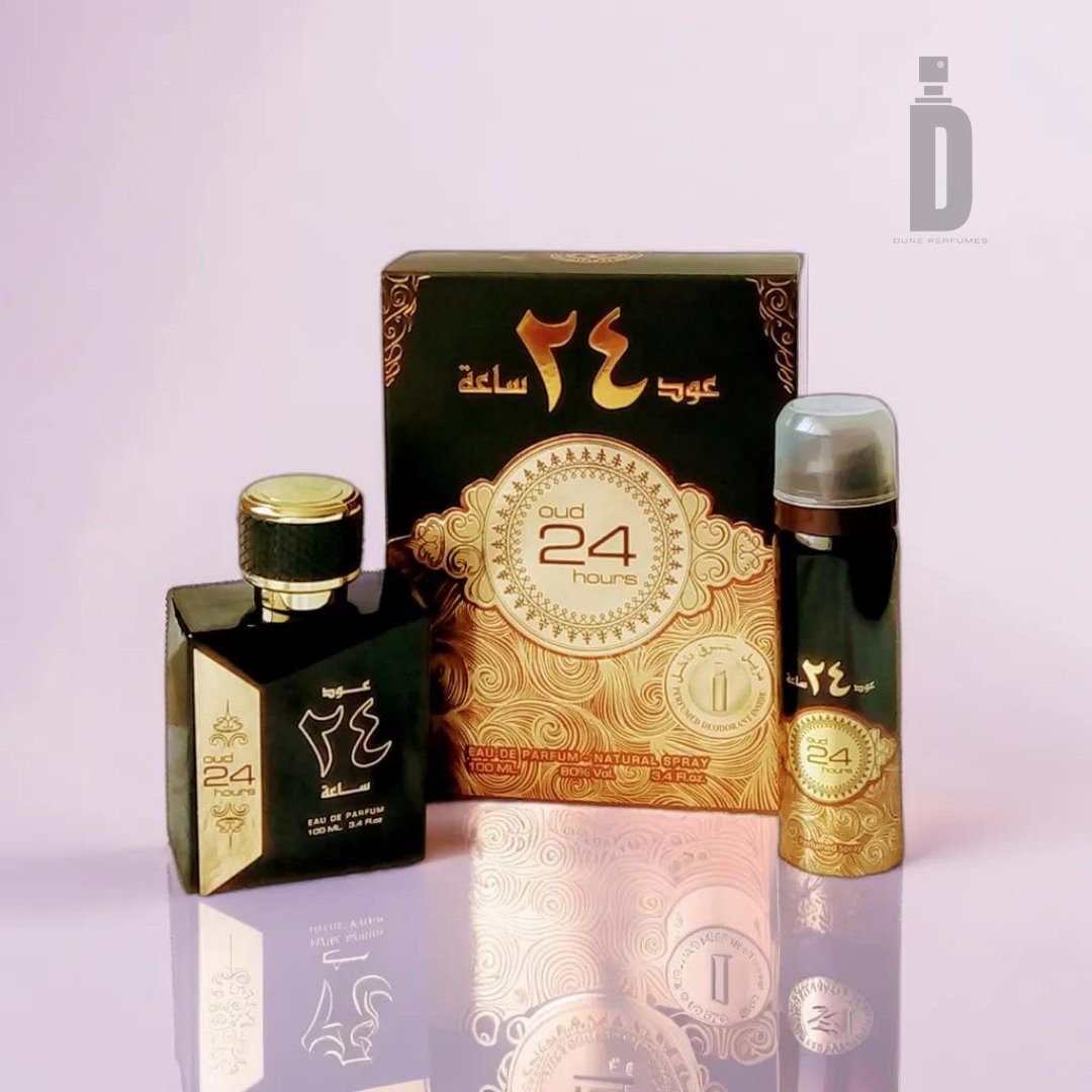 A set of fragrance products from Ard Al Zaafaran, featuring Oud 24 Hours 100ml EDP in a square bottle, and a 50ml deodorant in a cylindrical spray can, both housed in a rectangular box. All items are adorned with intricate gold patterns and Arabic text, predominantly in black and gold colors. The logo "Oud 24 Hours" is prominently displayed.