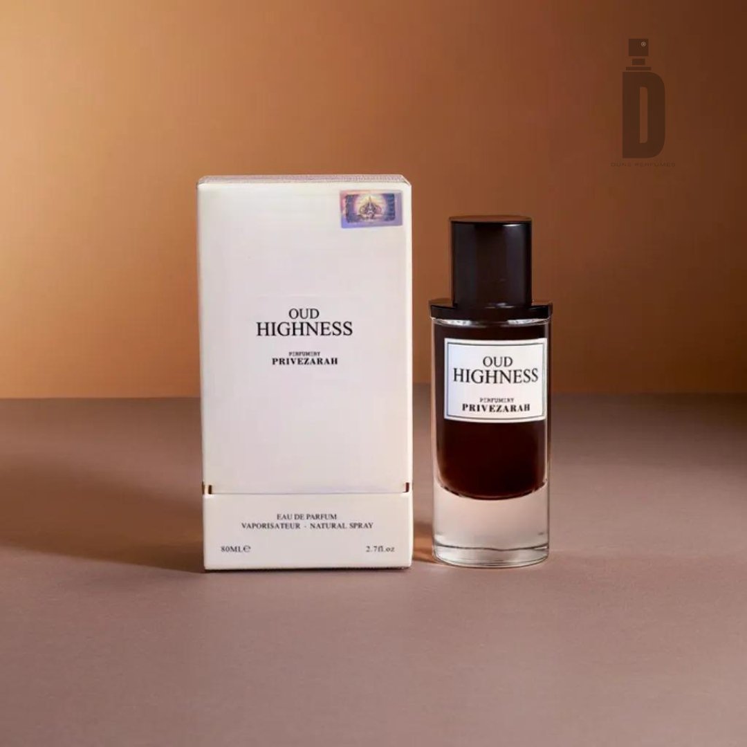 A bottle of Oud Highness 80ml EDP by Paris Corner stands next to its matching box on a brown surface. This luxury perfume features a cylindrical bottle with a dark cap, containing deep amber liquid. The white box adorned with black text and subtle decorative elements enhances the sophisticated fragrance inside.