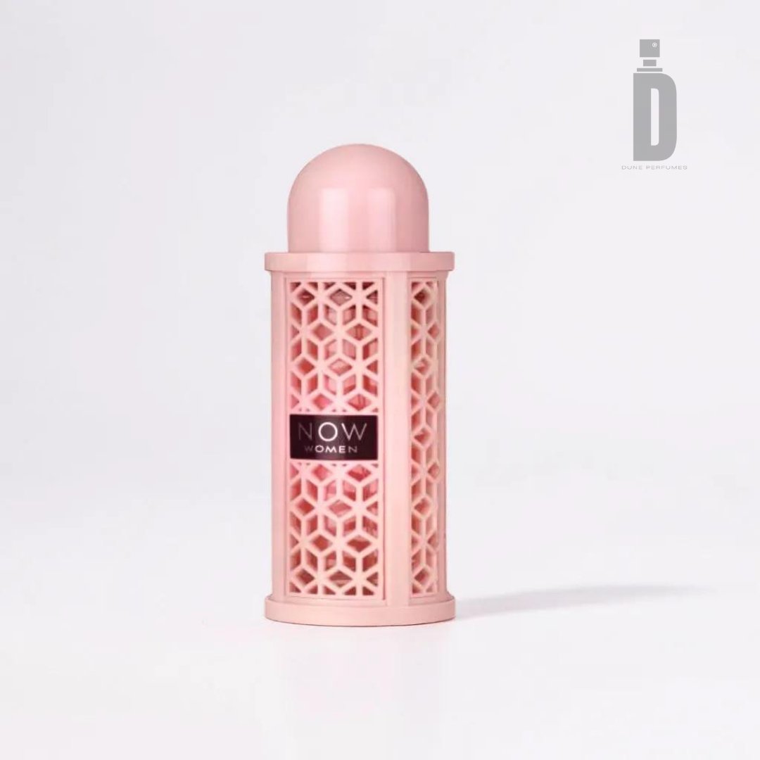 A pink cylindrical container adorned with a geometric lattice pattern, labeled "Rave Now Women 100ml EDP - Lattafa" against a black background. The container features a rounded cap and is set against a white backdrop. The "D" logo with "DIYAR PERFUMES" appears in the top right corner, suggesting fruity notes and warm undertones.