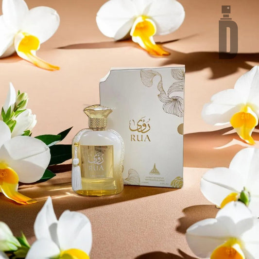 A bottle of Rua 100ml EDP - Paris Corner perfume stands beside its matching ornate box. The scene is artfully decorated with white and yellow flowers, exuding feminine elegance and creating an ambiance reminiscent of a Paris Corner.