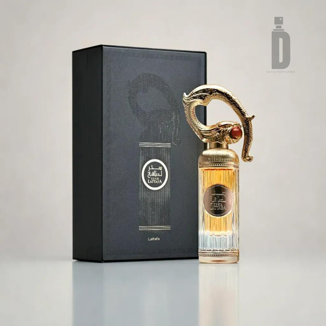The Sehr Lattafa 100ml EDP by Lattafa features a luxurious bottle with an intricately designed gold cap resembling a serpent, paired beautifully with its matching black box adorned with elegant gold designs and text. The bottle's transparent lower half reveals the amber-colored perfume inside, while its enchanting fragrance epitomizes luxury and sophistication.