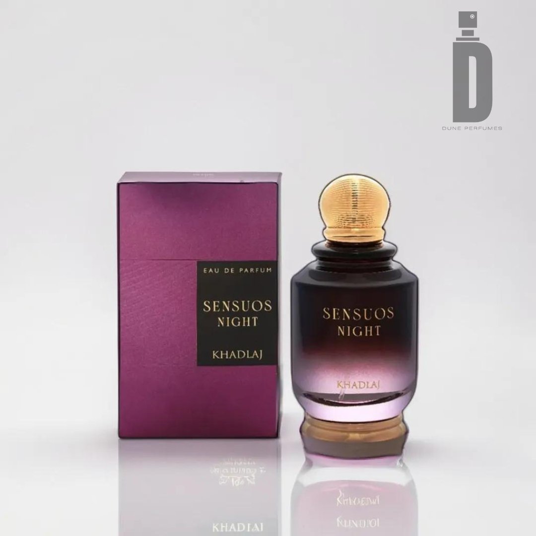 This image showcases a bottle of Sensous Night 100ML EDP by Khadlaj. The seductive fragrance is housed in a bottle with a gradient design, transitioning from dark purple at the bottom to light yellow at the top, capped in gold. Its matching box is elegantly purple with the same label.