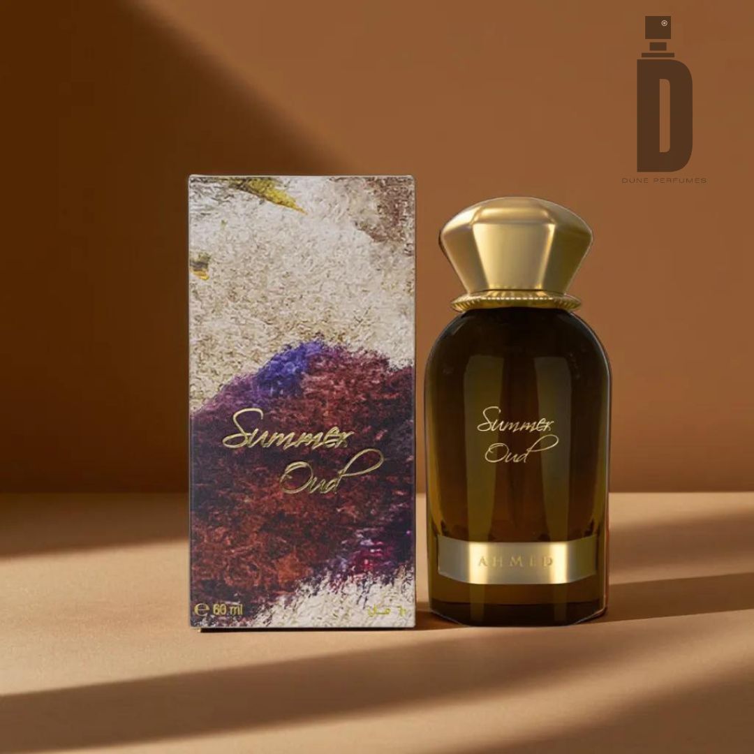 The "Summer Oud 60ml EDP - Ahmed Al Maghribi" Eau de Parfum, by Ahmed Al Maghribi, is displayed beside its box on a beige surface against a brown backdrop. The dark bottle with a gold cap and label radiates elegance, while the box showcases an abstract design adorned with golden text that highlights the enchanting fragrance notes of Summer Oud.
