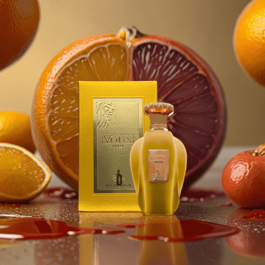 A bottle and box of Voux Zeste 100ml EDP by Paris Corner are displayed with fresh oranges, grapefruit, and tangerines, emphasizing its lively citrus scent with juice droplets glistening on their surfaces.